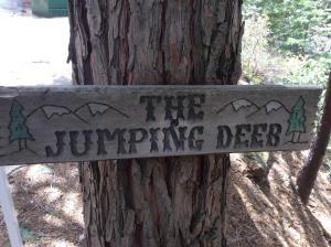a sign on a tree that reads the jumping deer at Jumping Deer in Yosemite West +3 photos