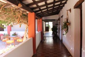 a hallway of a house with a table and chairs at El Hospedaje in Cafayate