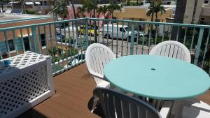 a blue table and chairs on a balcony at Atlantic Sands Beach Suites in Hollywood