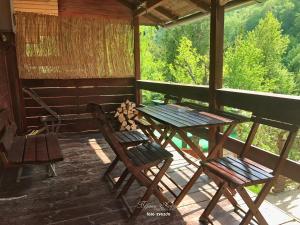 a table and chairs on the porch of a cabin at Little heaven 2 in Mandići
