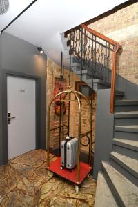 a suitcase on a red platform next to a staircase at Pera Luna Residence in Istanbul