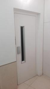 a white door with a black window in a room at Hotel Inglés in Barcelona