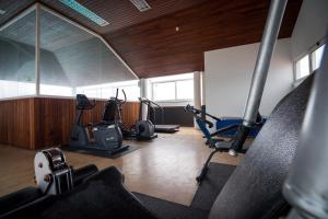 a gym with several exercise equipment in a room at Hotel Talisman in Ponta Delgada