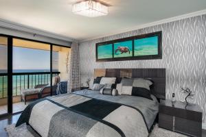A bed or beds in a room at Waikiki Beach Tower