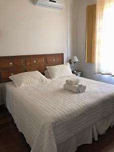 a bedroom with a bed with two towels on it at Pousada Vovô Chiquinho in Tiradentes