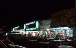 an outdoor cafe with tables and chairs at night at The Regency Garden Hotel in Ipoh