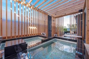 a swimming pool in a house with a wooden wall at Hotel Zen Ichinomiya (Adult Only) in Ichinomiya
