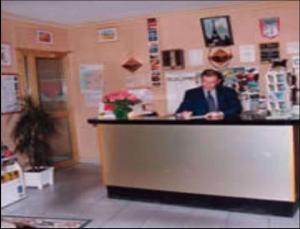 a man sitting at a counter in a room at Hotel Paris Bercy in Paris