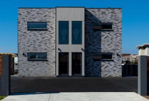 a large brick building with a large window at Ulverstone Waterfront Apartments in Ulverstone