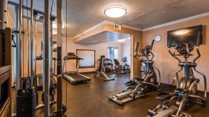 a gym with several tread machines in a room at Best Western InnSuites Phoenix Hotel & Suites in Phoenix