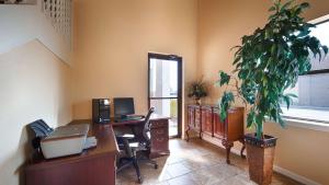 an office with a desk with a computer and a plant at Best Western Inn Russellville in Russellville