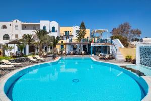 a large swimming pool in front of a building at Kalimera Hotel in Akrotiri