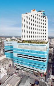 a large blue and white building in a city at Lee Gardens Plaza Hotel - SHA Plus in Hat Yai
