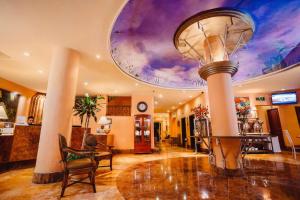 a lobby with a ceiling with a painting on it at Best Western Posada Freeman in Mazatlán