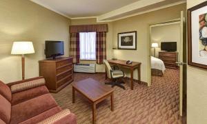 a hotel room with a couch and a desk and a bed at The Water Tower Inn - BW Premier Collection in Sault Ste. Marie