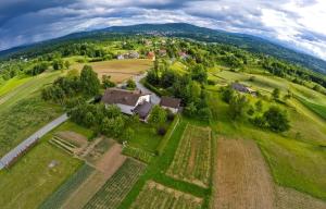 an aerial view of a house in a field at Guesthouse Obitelj Paulic in Slunj