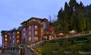 a large building on a hill at night at RK Sarovar Portico in Srinagar