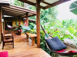 a porch of a house with a hammock at Phoxay Ngam Resort in Vang Vieng