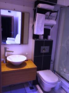 a bathroom with a sink and a toilet and a mirror at Masal Otel in Kocaeli