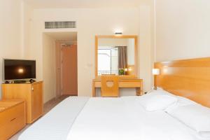 A bed or beds in a room at Athinais Hotel