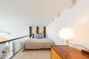 a bedroom with a bed and a table with a lamp at La Piazza Apartment in Dubrovnik