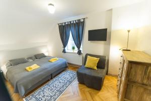 Posteľ alebo postele v izbe v ubytovaní Babylon Apartmány