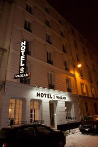 a hotel with a car parked in front of it at Royal Wagram in Paris