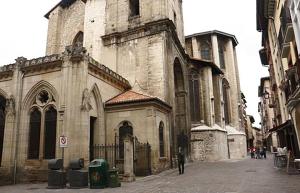 a man is standing in front of a church at Luxury Cercas Bajas Vitoria in Vitoria-Gasteiz