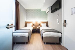 Postel nebo postele na pokoji v ubytování Melrose Hotel