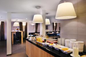 a buffet in a hotel with plates of food at Hotel Garni Testa Grigia in Zermatt
