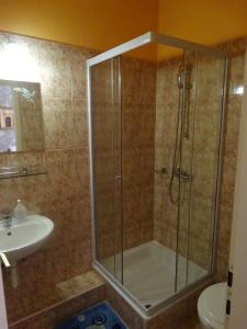 a bathroom with a shower and a sink at Budai Panzió in Székesfehérvár