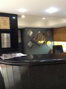 a counter in an office with a desk with papers on the wall at Hotel Azores in Mexico City