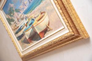 a framed painting of a painting of boats at B&B La Casa Nel Giardino in Piano di Sorrento