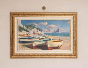 a framed painting of boats on a beach at B&B La Casa Nel Giardino in Piano di Sorrento
