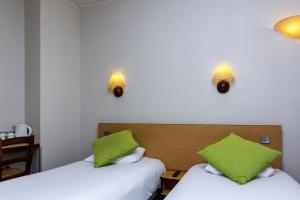 a hotel room with two beds and two lamps at Campanile Paris 15 - Tour Eiffel in Paris