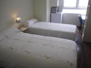 Posteľ alebo postele v izbe v ubytovaní Hostal El Estudio