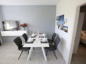a white table with black chairs in a room at Modern holiday home with pool in Bibinje