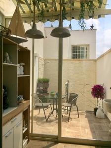 a kitchen with a patio with a table and chairs at Dimore di Mare in San Pietro Vernotico