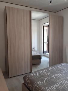 a bedroom with a bed and a large mirror at Laura's Lake Room in Arona