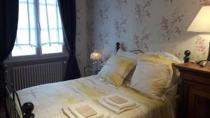 a bedroom with a bed with white sheets and pillows at La Vigne Vierge in Châteauneuf-sur-Loire +20 photos