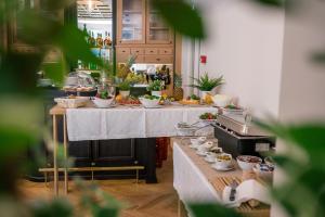 a kitchen with a table with food on it at Public House Hotel in Belgrade