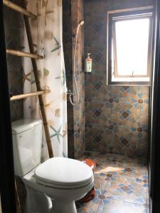 a bathroom with a toilet and a window at Halo Bay Homestay in Ha Long +136 photos