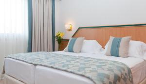 Postel nebo postele na pokoji v ubytování Hotel Praga