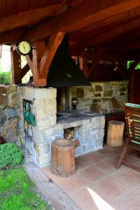 a stone fireplace with a clock on top of it at Apartments Ve Dvoře in Mosty u Jablunkova