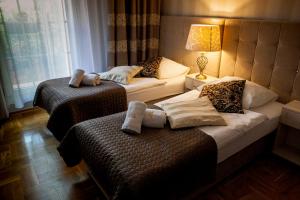 Posteľ alebo postele v izbe v ubytovaní Aparthotel Oberża