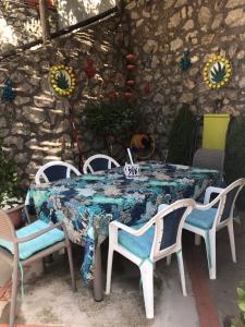 een tafel en stoelen met een blauwe en witte tafel bij Casetta Anacaprese in Anacapri