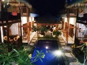 a resort with a swimming pool at night at Gili Desa in Gili Trawangan