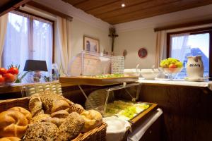 a kitchen with a basket of bread and other foods at Hotel Garni Wenglhof in Sankt Gilgen