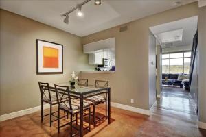 a kitchen and dining room with a table and chairs at Littlefield Lofts #502 in Austin