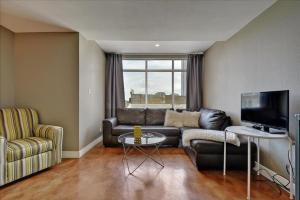 a living room with a couch and a tv at Littlefield Lofts #502 in Austin